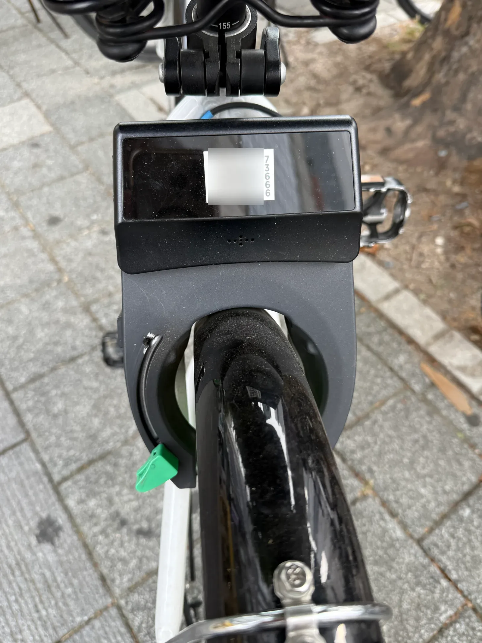 The terminal on the back of a Ttareungyi with its QR sticker blurred and the bike number 73666 beside it