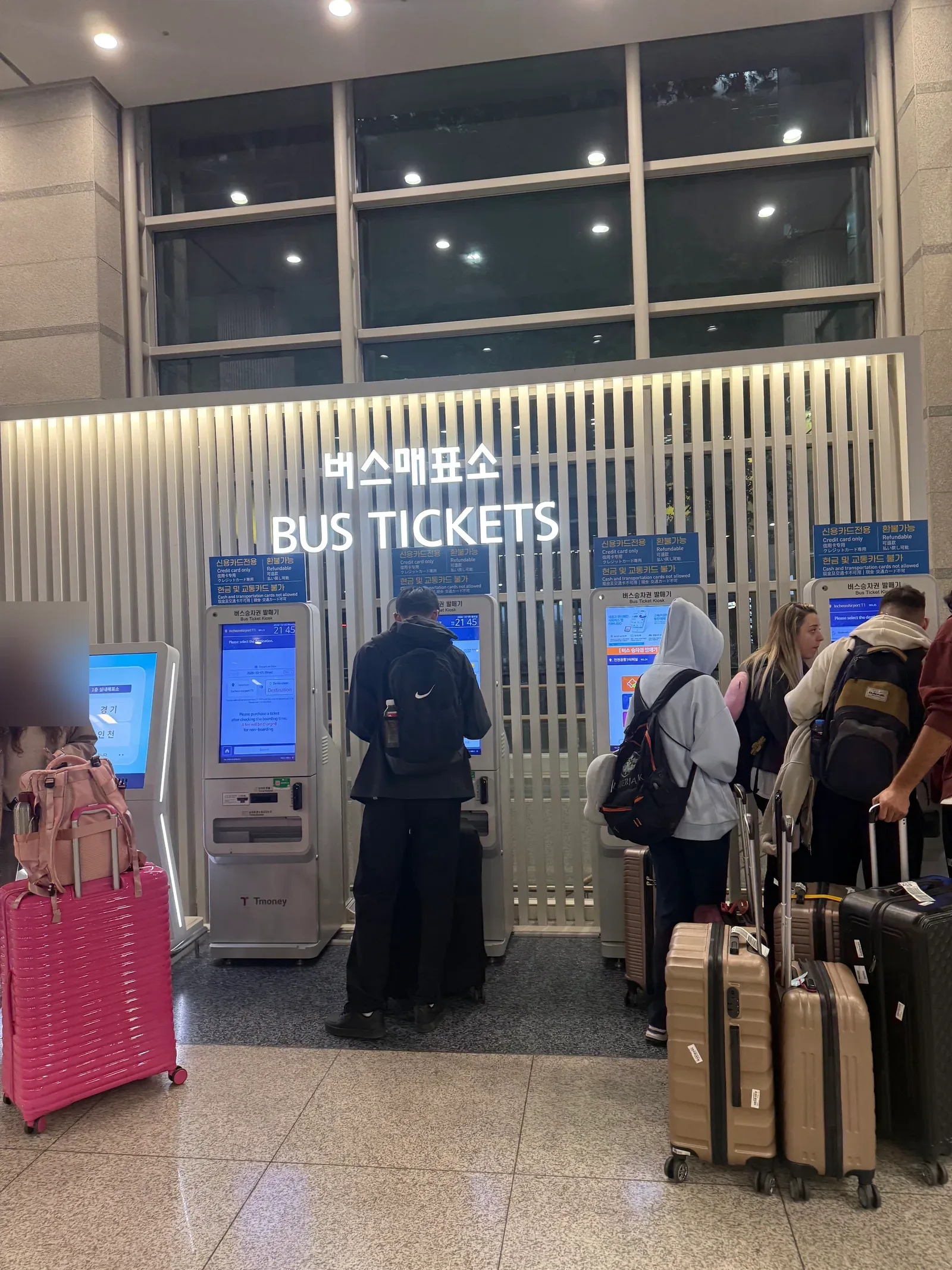 Self-service bus ticket kiosks under a sign reading Credit card only, Refundable, Cash and transportation cards not allowed
